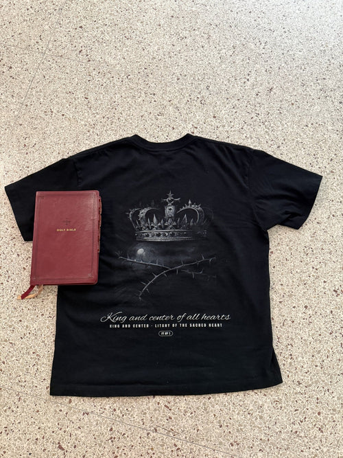 King and Center engraved back print with Bible, black tee, flat lay