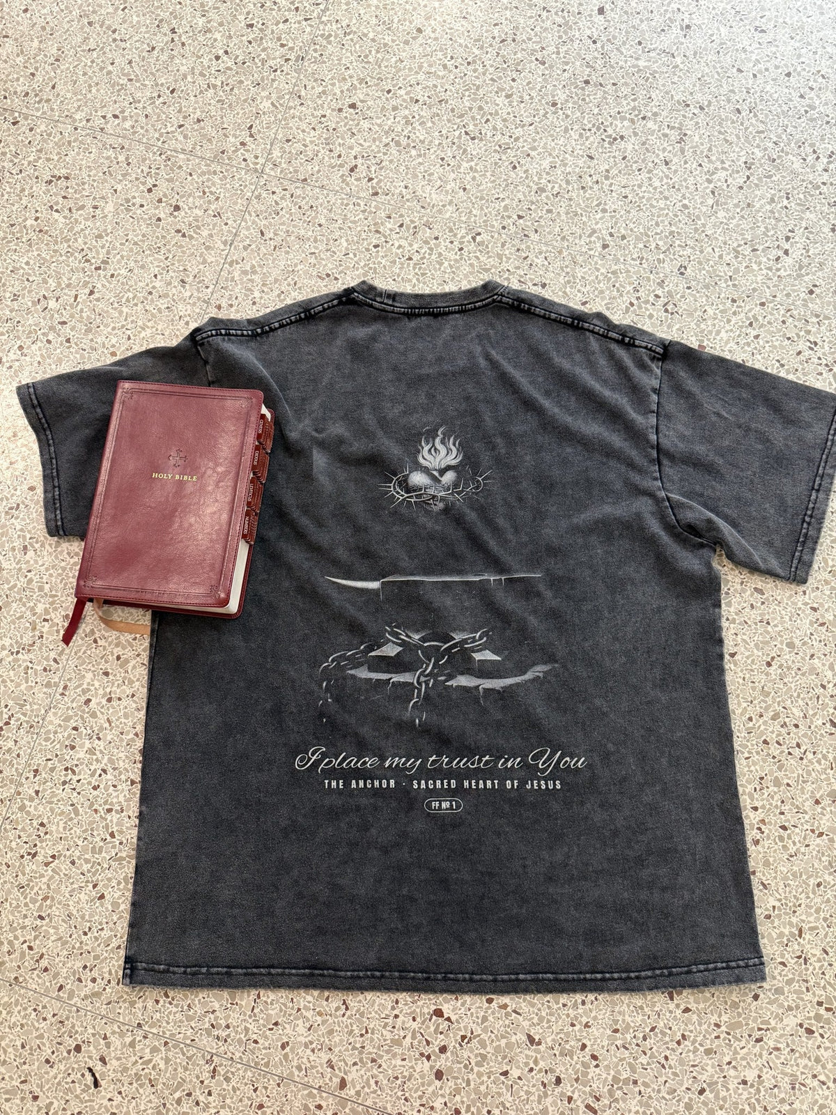 The Anchor engraved back print, washed black heavyweight tee, flat lay