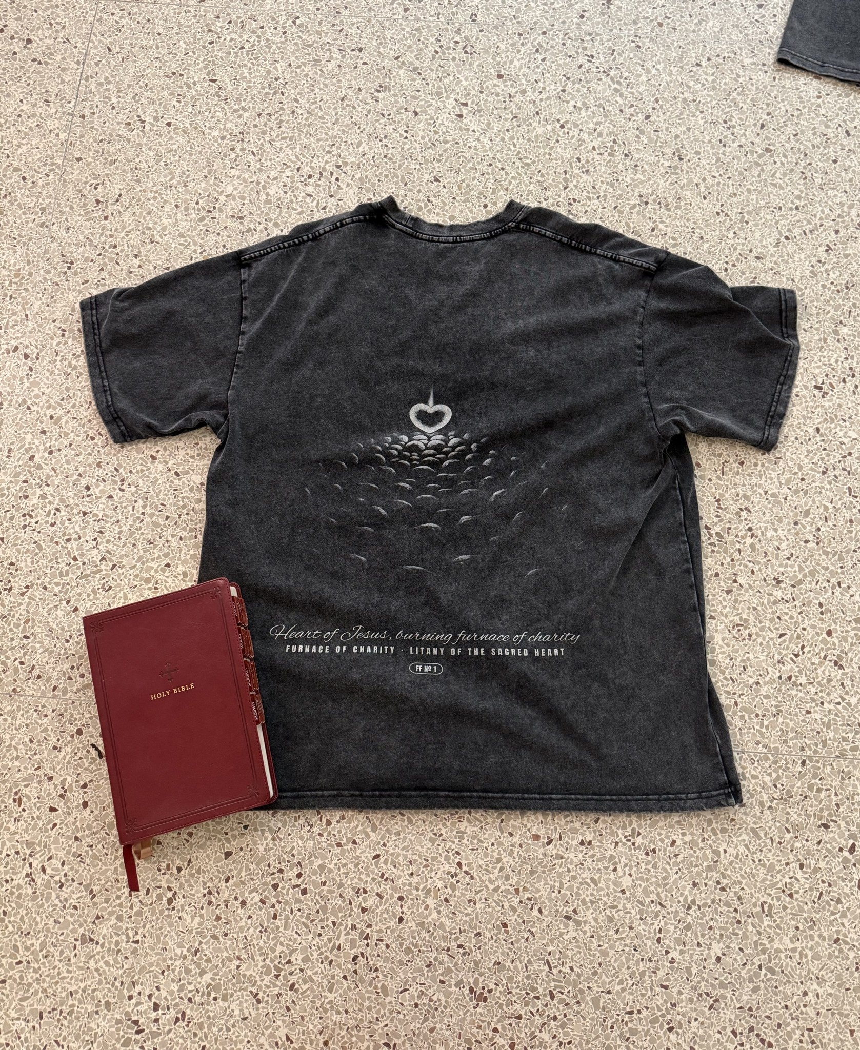 Furnace of Charity engraved back print, washed black tee, flat lay