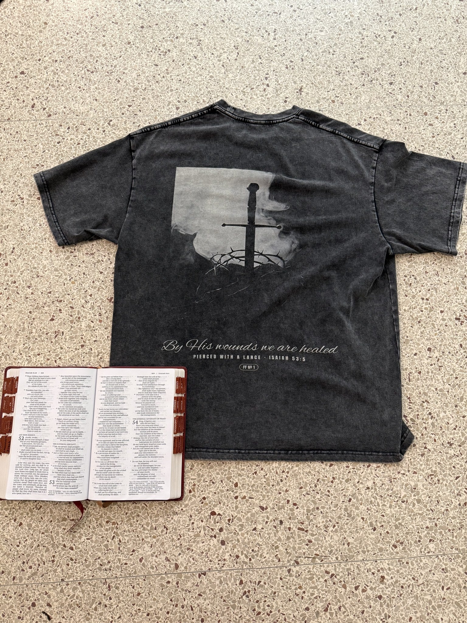 Pierced with a Lance engraved back print with Bible open to Isaiah 53, flat lay